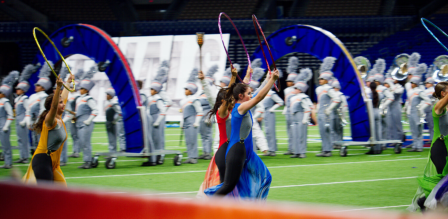 Color guard members move swiftly across the field shortly into the band's run in the finals. [see several more swarm shots]